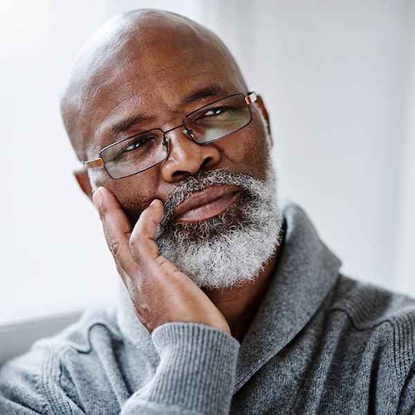 An older man wondering, how do dental implants work?