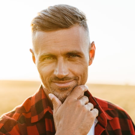 A mature man smiling after restoring his smile at 832-637-4977