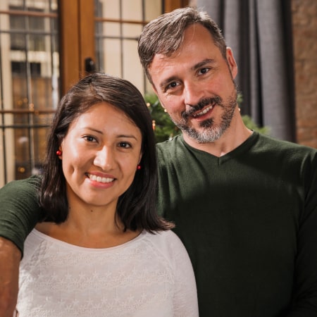 A couple smiling while hugging each other