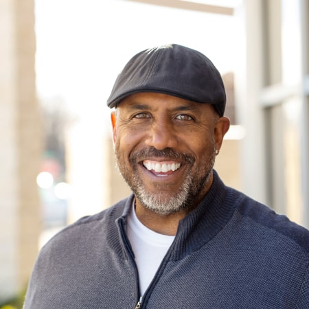 A mature man showing off his new dental implants