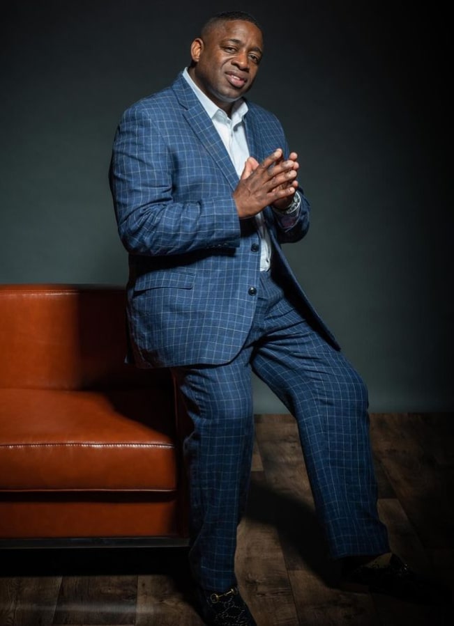 Dr. Collins smiling and asking if you are happy with your smile