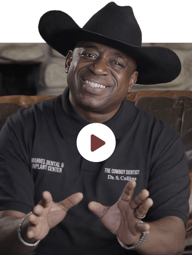Dr. Samuel Collins, also known as The Cowboy Dentist, smiling while wearing a cowboy hat at Manvel Dental & Implant Center