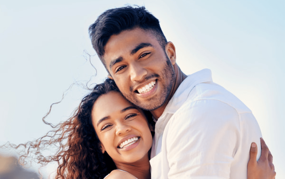 A couple smiling and hugging