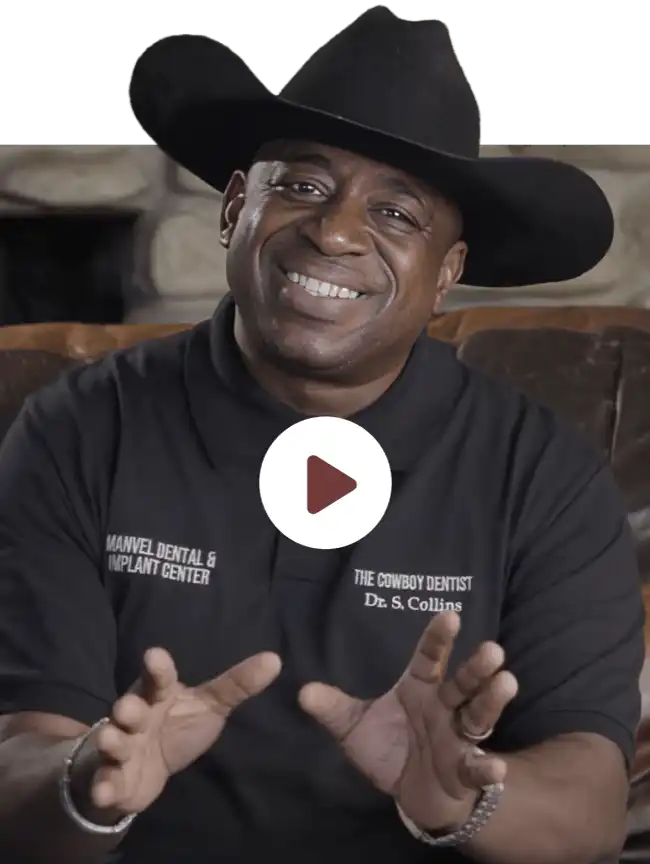Dr. Samuel Collins, also known as The Cowboy Dentist, smiling while wearing a cowboy hat at Manvel Dental & Implant Center